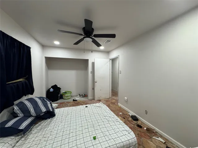 a bedroom with a bed and a walk in closet