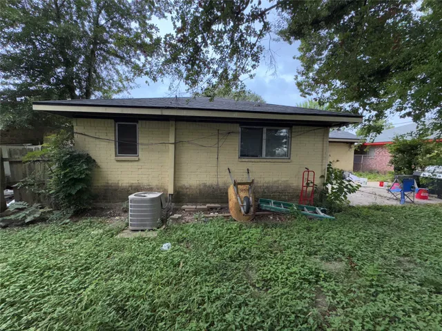 a backyard of a house with table and chairs