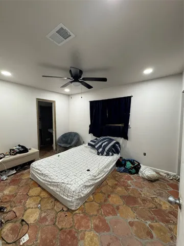 a bedroom with a bed and a television