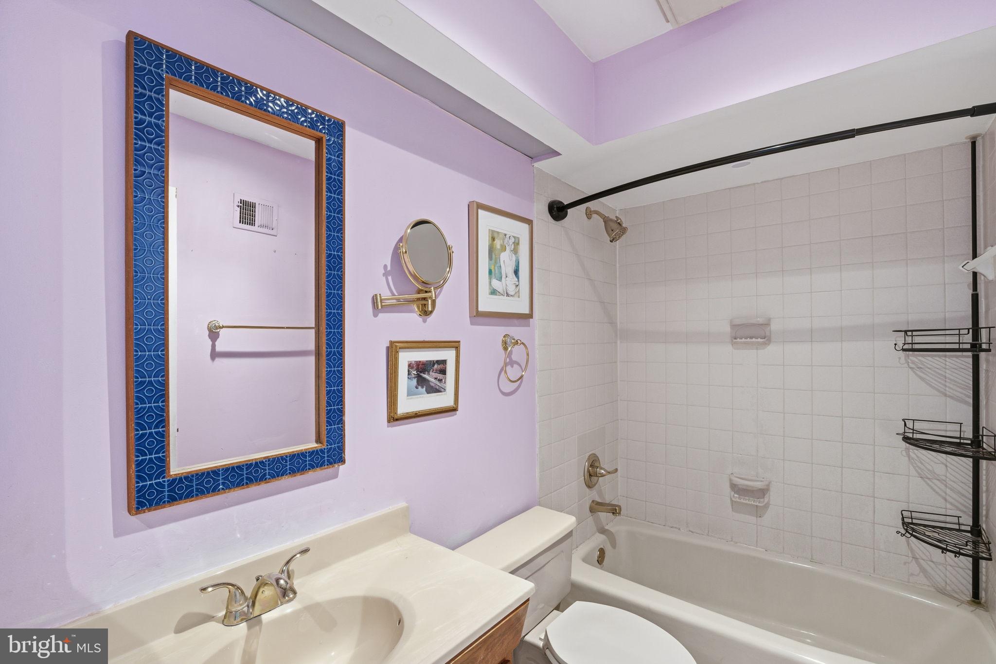 1066 Paper Mill Court, Unit 1066 Washington, DC 20007 - Photo 12 of 25 a bathroom with a granite countertop shower sink vanity mirror and toilet