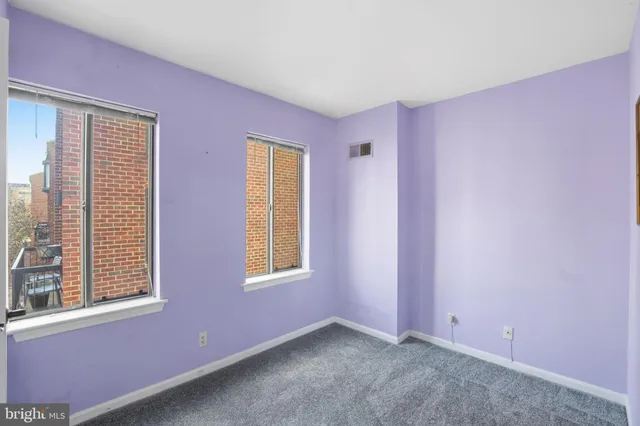 a bathroom with a granite countertop shower sink vanity mirror and toilet