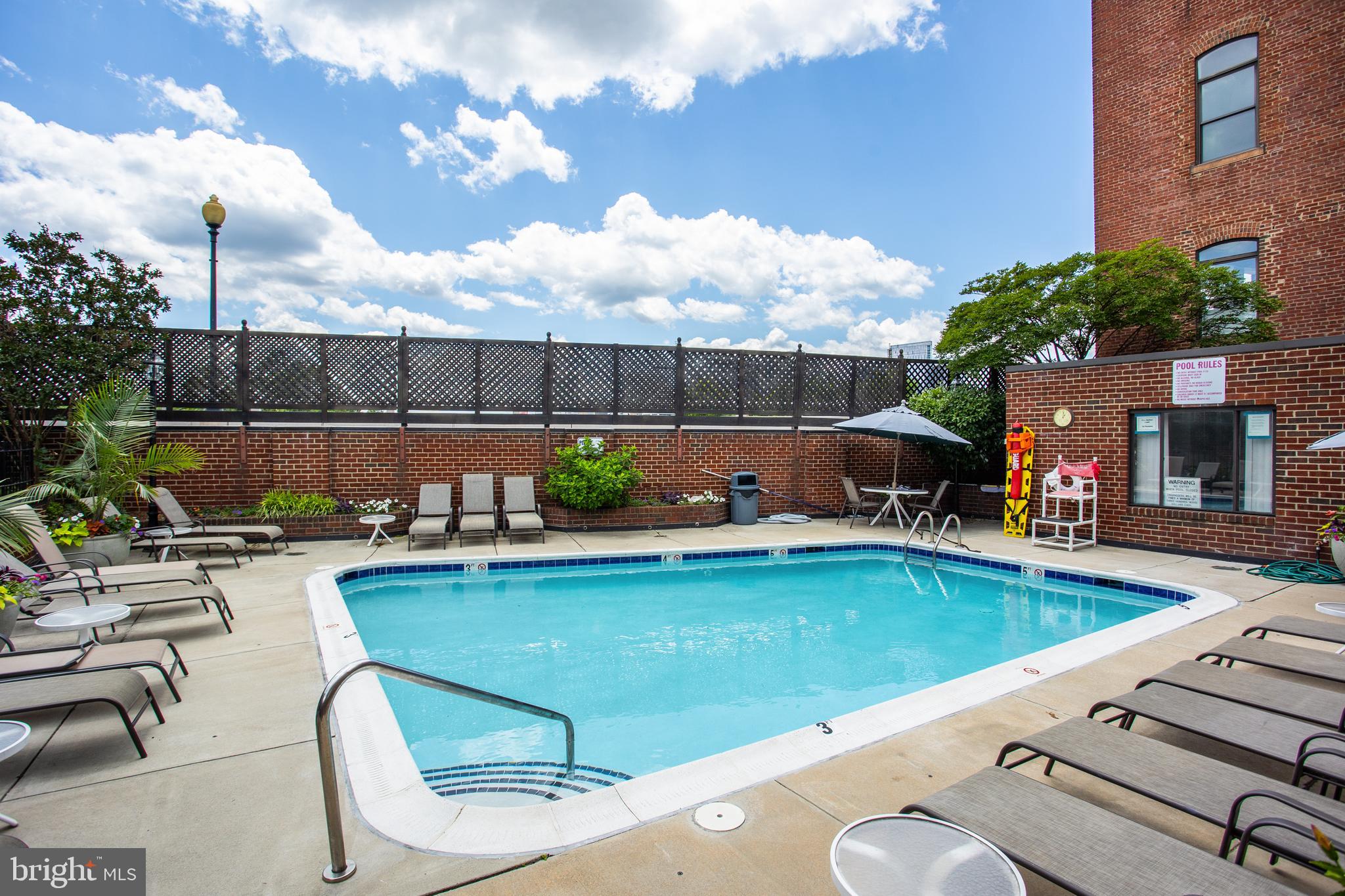1066 Paper Mill Court, Unit 1066 Washington, DC 20007 - Photo 16 of 25 a view of swimming pool with outdoor seating and plants