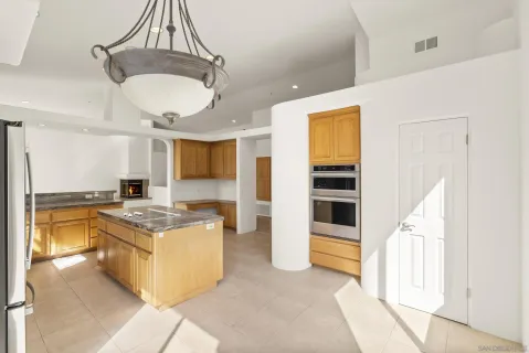 a kitchen with stainless steel appliances granite countertop a stove oven and a refrigerator with cabinets