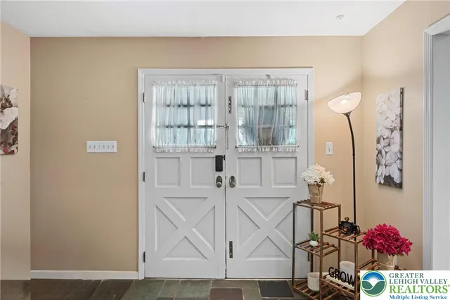 a view of hallway with wooden floor and cabinet