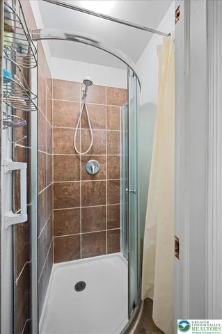 a bathroom with a shower and a window