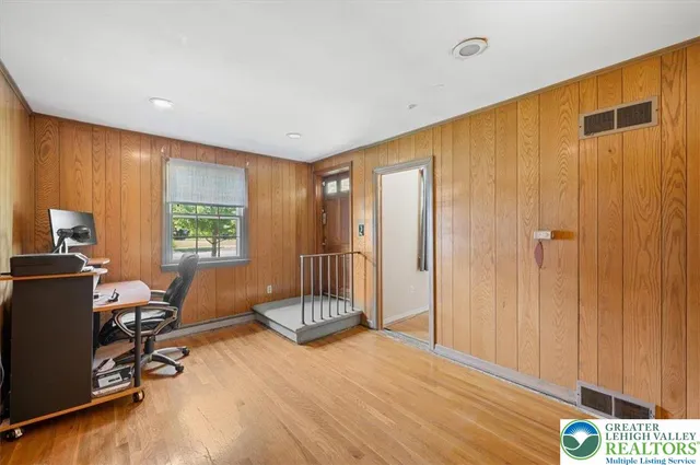 a view of a livingroom with workspace and a window