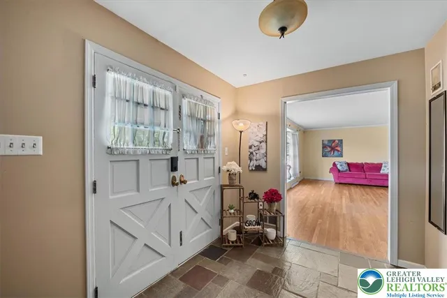 a view of living room filled with furniture and a chandelier