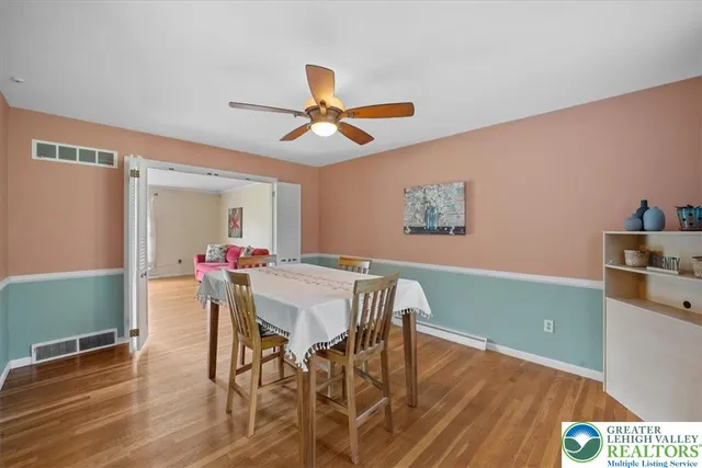 a view of a dining room with furniture and wooden floor