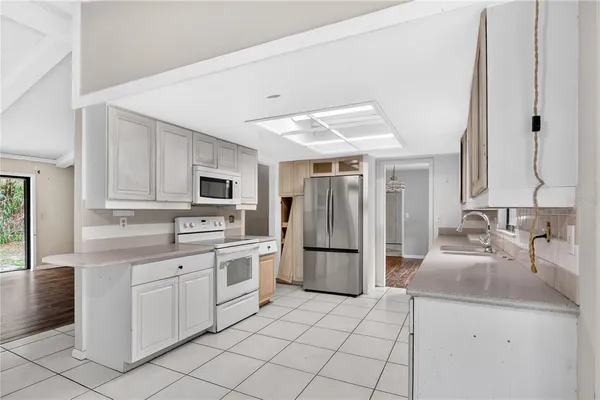 a kitchen with a sink appliances and cabinets