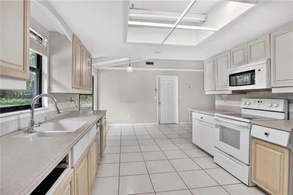 a kitchen with a sink appliances and cabinets