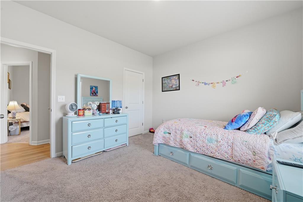 1269 Covered Bridge Road Covington, GA 30016 - Photo 21 of 31 a room with a bed and a dresser