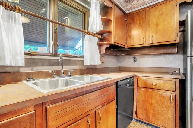 a kitchen with stainless steel appliances granite countertop a sink and cabinets