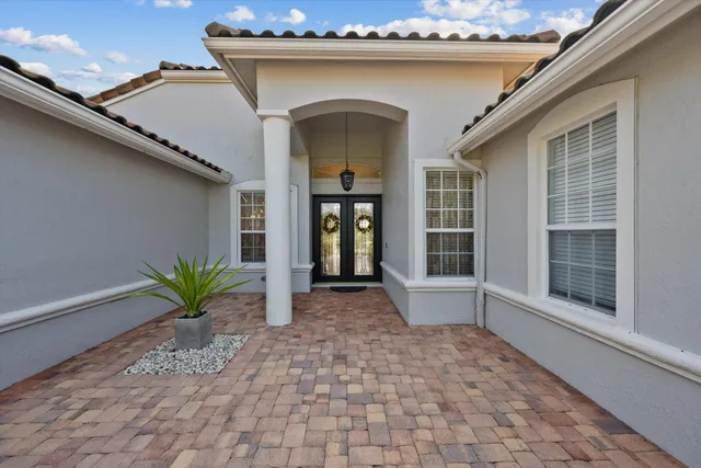 a living room with a couch and a chandelier