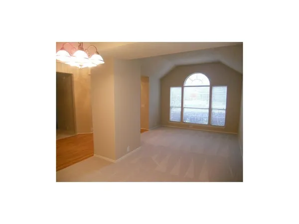a view of a room that has a large window and mirror