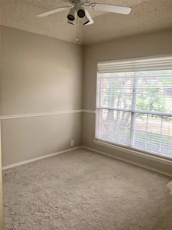 an empty room with a empty space and windows