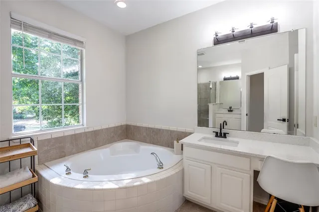 a bathroom with a bathtub and a sink