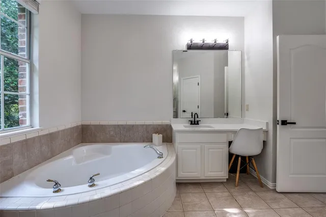 a bathroom with a tub sink and a mirror