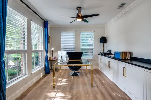 a large white kitchen with a large window a sink and a counter space