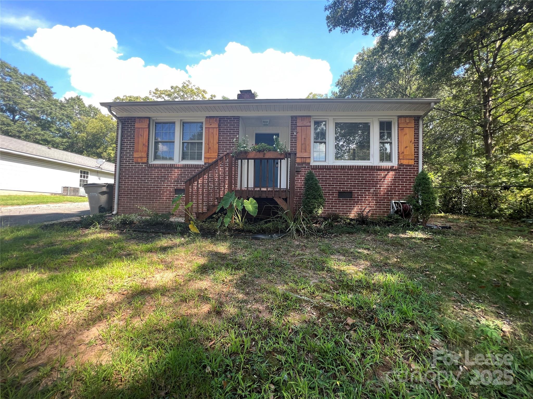 a view of a house with a yard and a porch