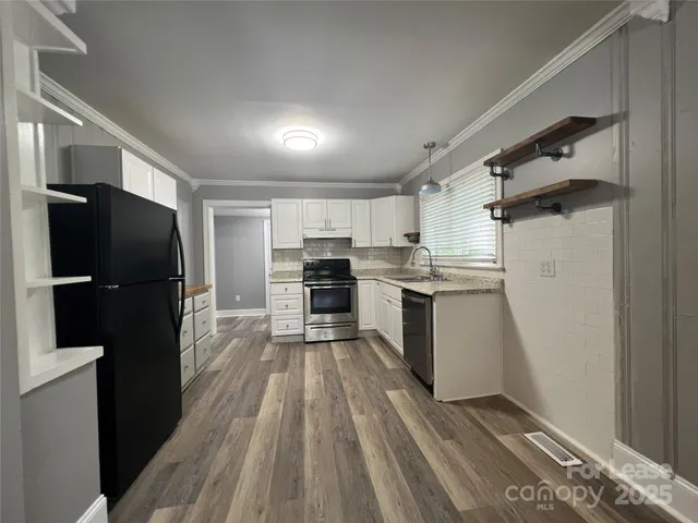 a kitchen with a refrigerator a sink and dishwasher