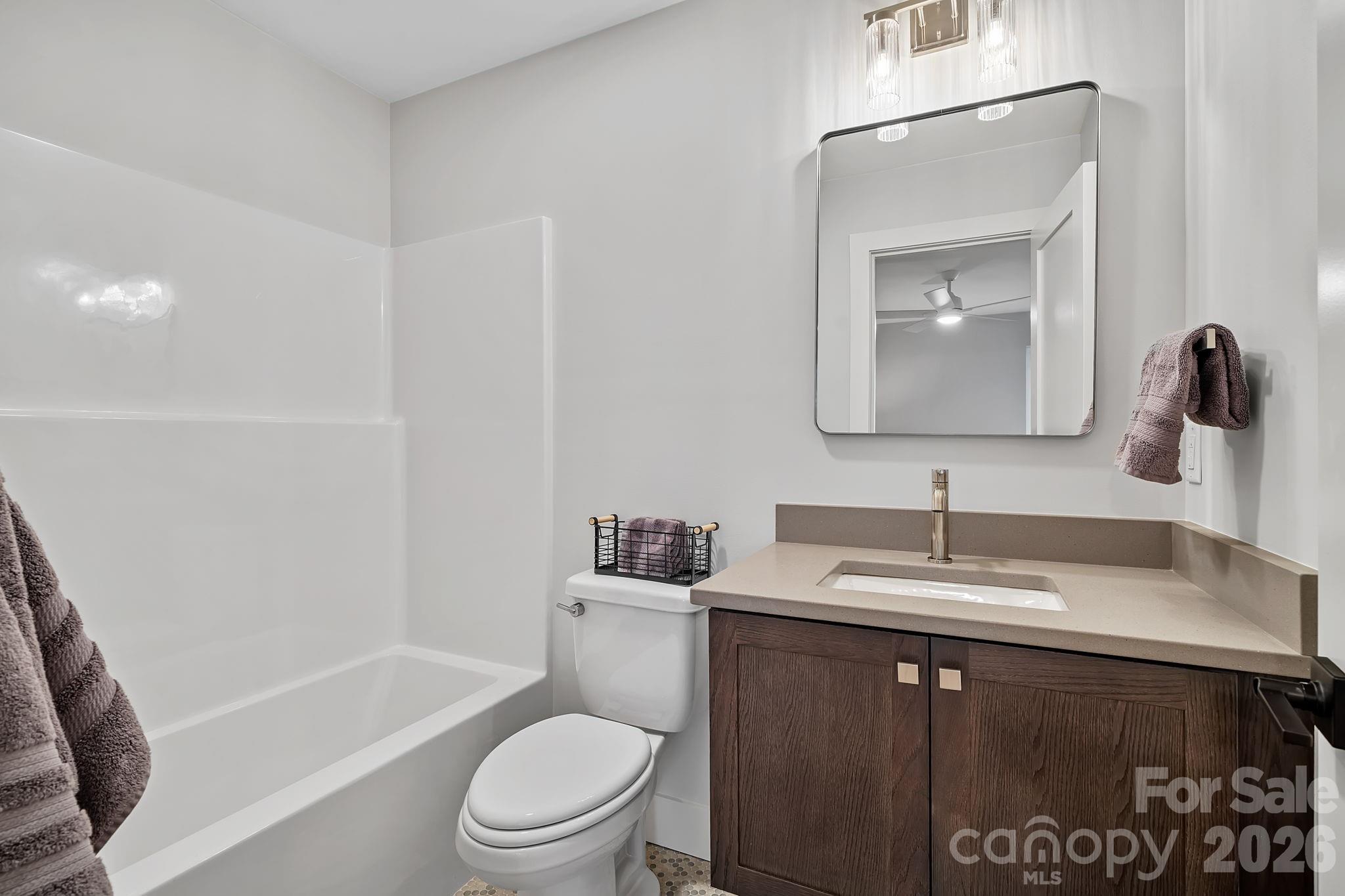 5 Gudger Road Asheville, NC 28715 - Photo 43 of 47 a bathroom with a granite countertop sink toilet and mirror