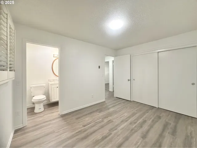 a view of a room with wooden floor and toilet