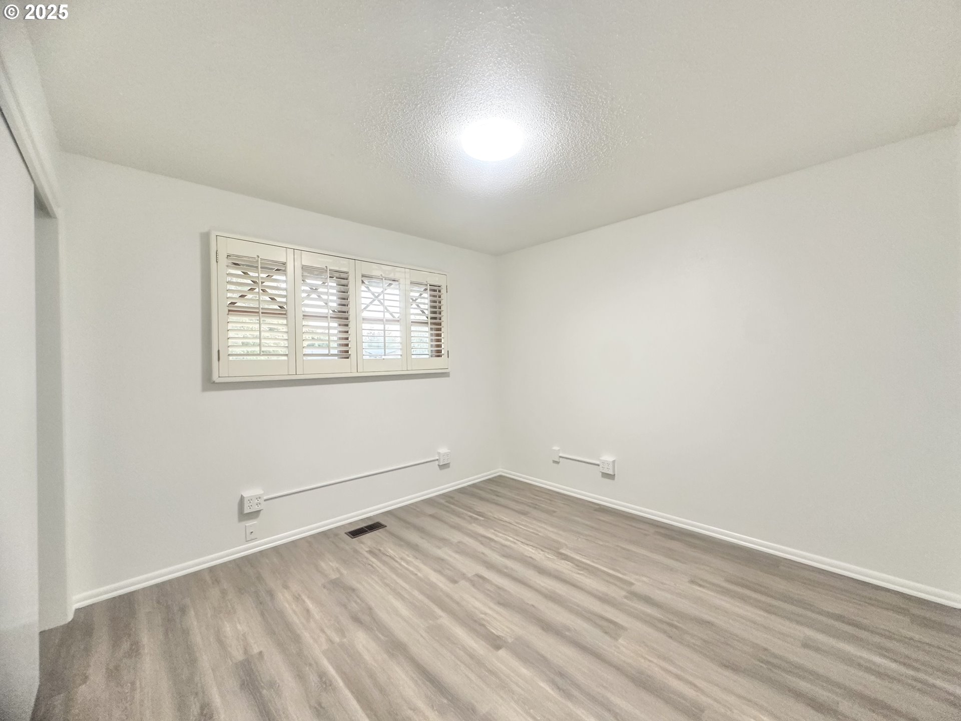 18505 Southeast Clinton Street Gresham, OR 97030 - Photo 17 of 39 an empty room with wooden floor and windows