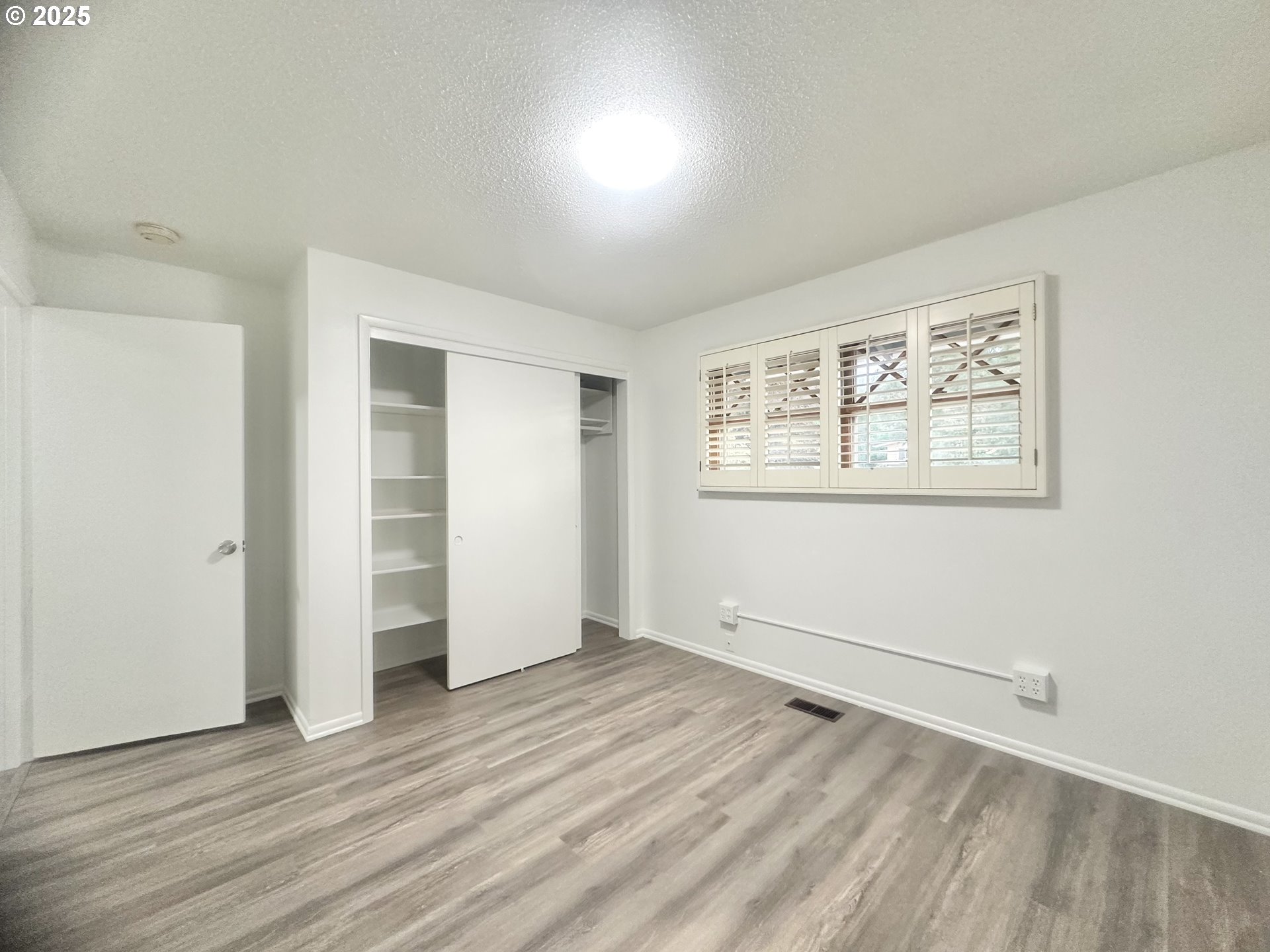 18505 Southeast Clinton Street Gresham, OR 97030 - Photo 18 of 39 an empty room with wooden floor and windows