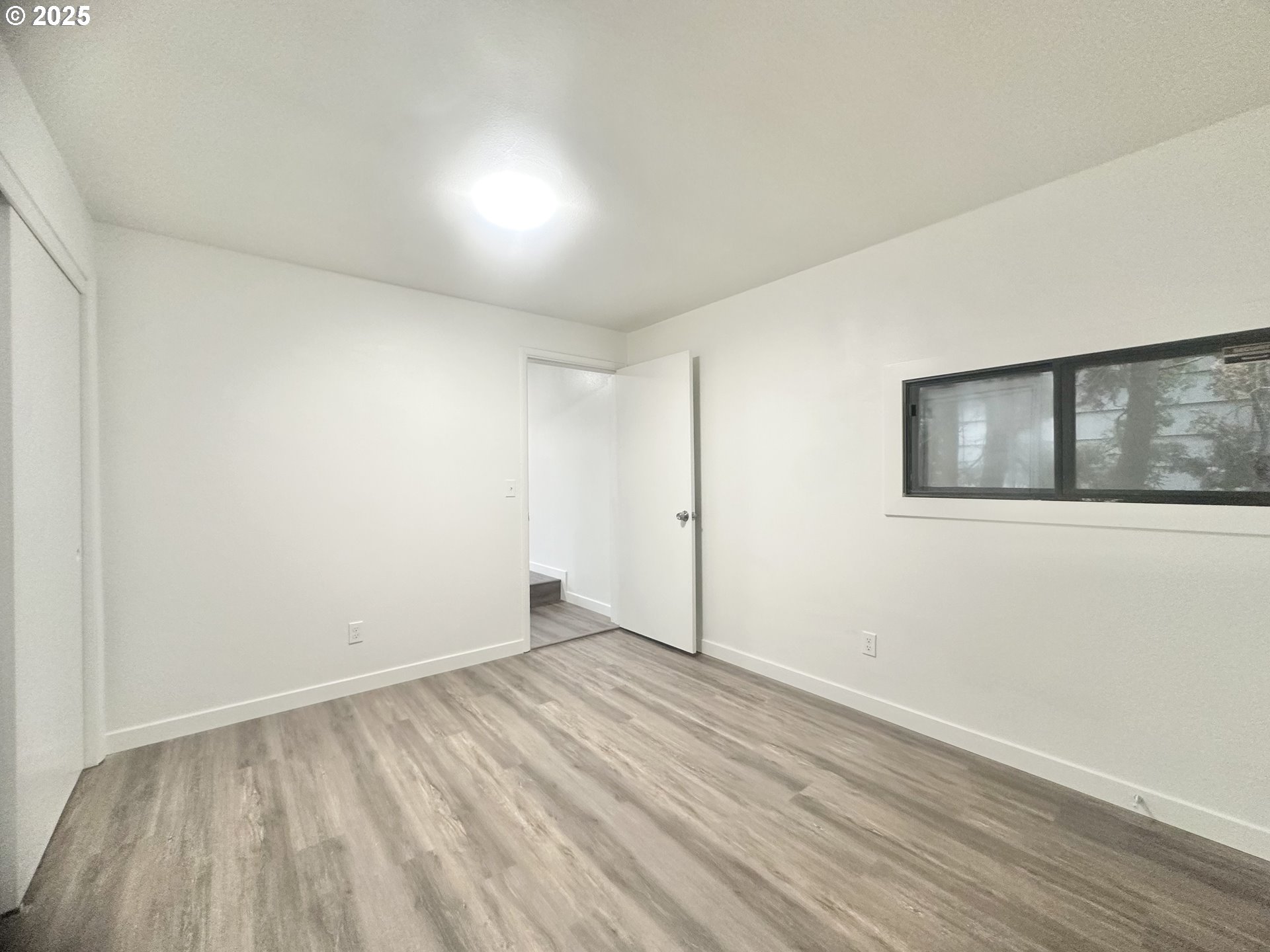 18505 Southeast Clinton Street Gresham, OR 97030 - Photo 20 of 39 a view of empty room with wooden floor and fan