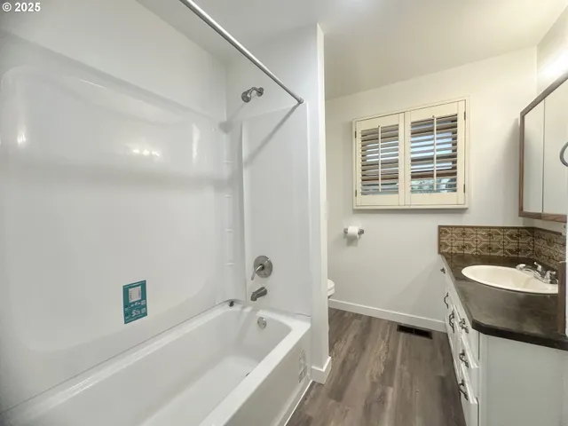a bathroom with a sink a bathtub and a toilet
