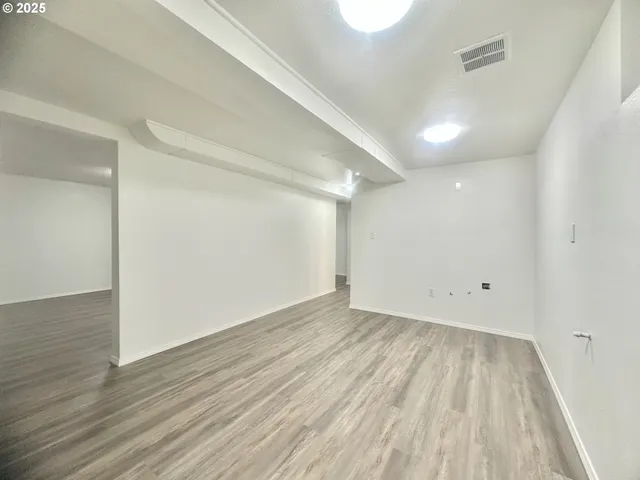 a view of room with wooden floor