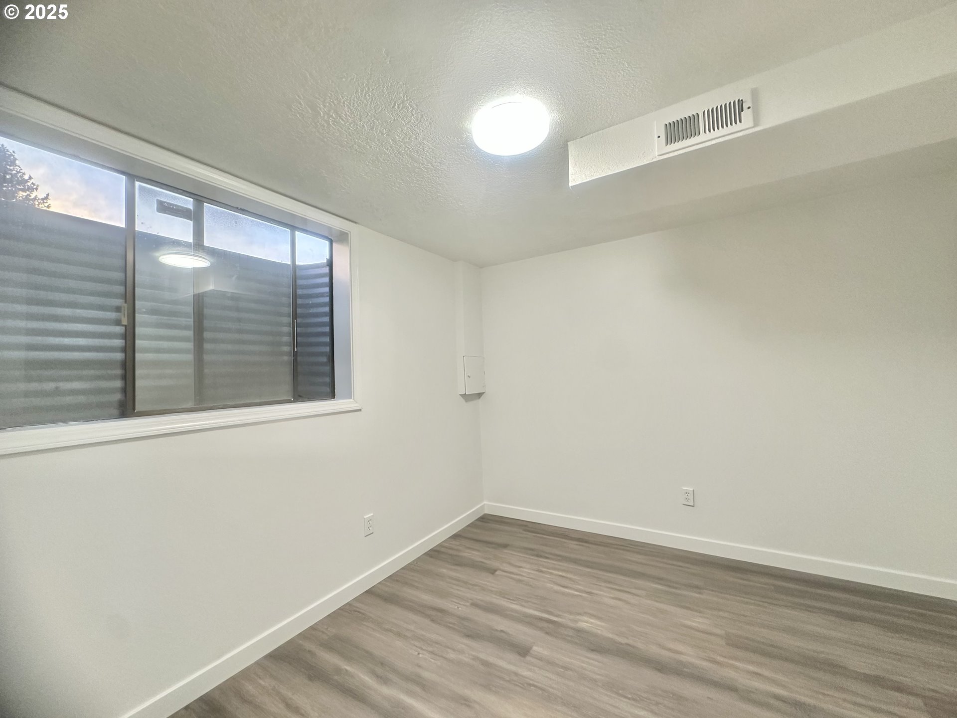 18505 Southeast Clinton Street Gresham, OR 97030 - Photo 29 of 39 a view of empty room with wooden floor and fan