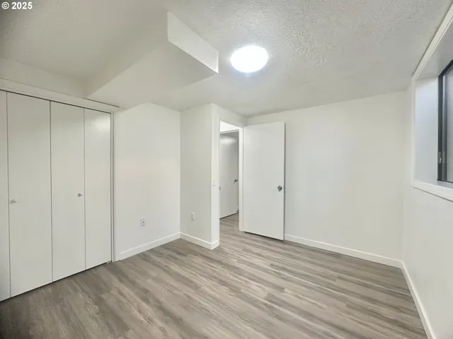 a view of an empty room and wooden floor