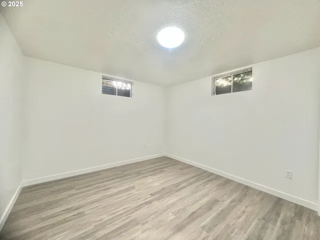 a view of a room with wooden floor and white wall