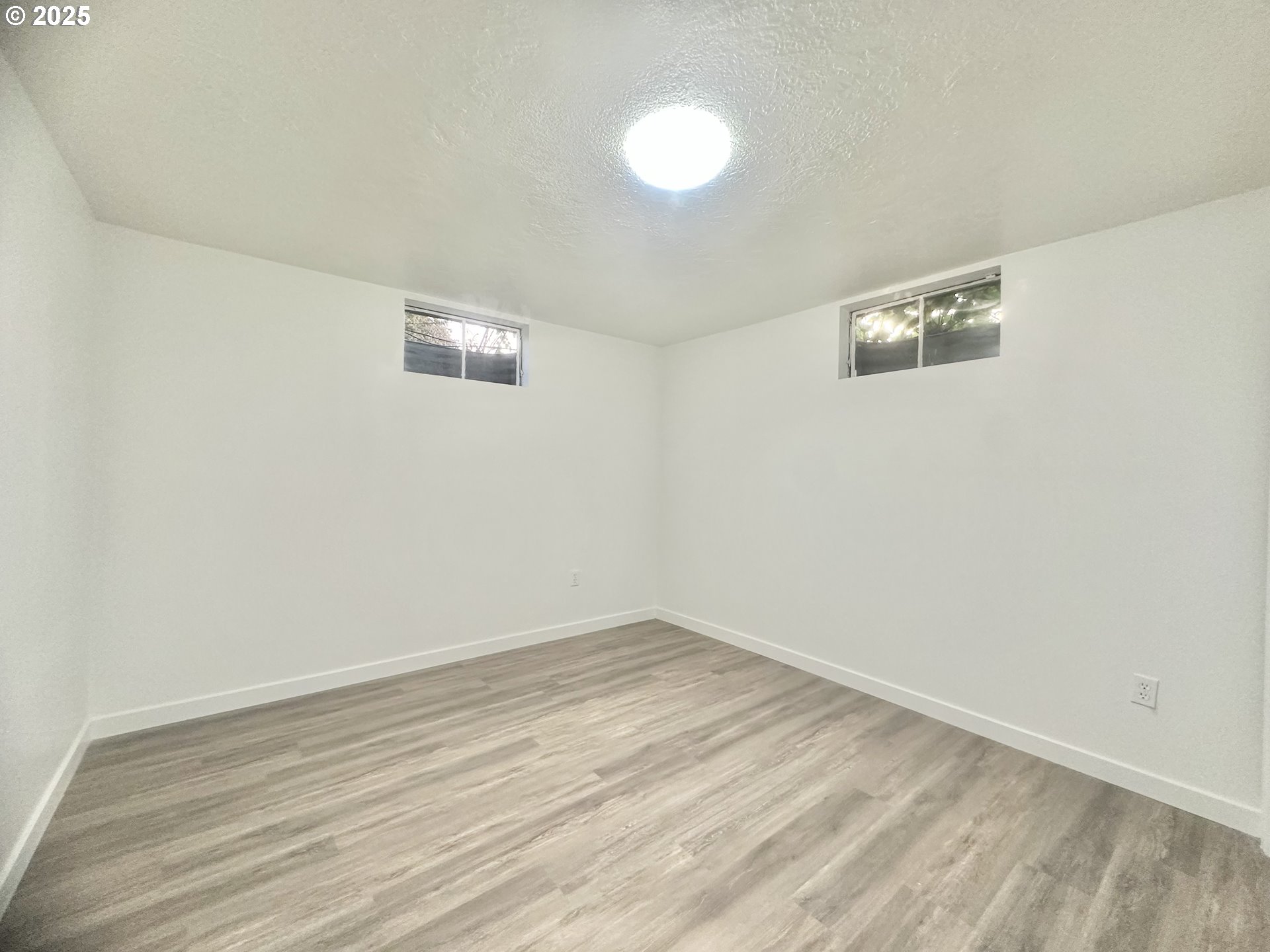 18505 Southeast Clinton Street Gresham, OR 97030 - Photo 31 of 39 a view of a room with wooden floor and white wall