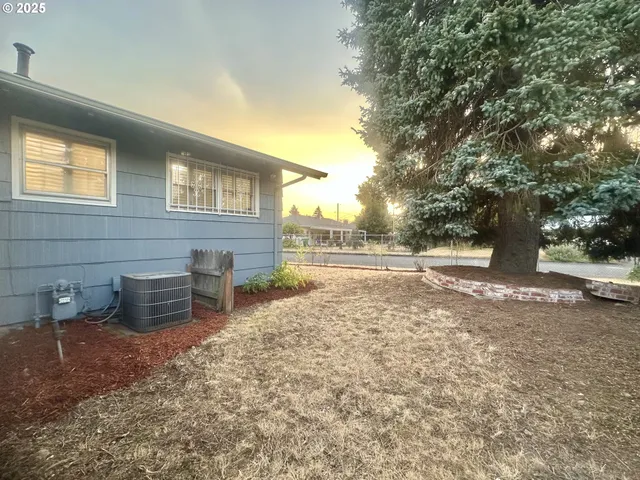 a view of a backyard with table and chairs and a fire pit