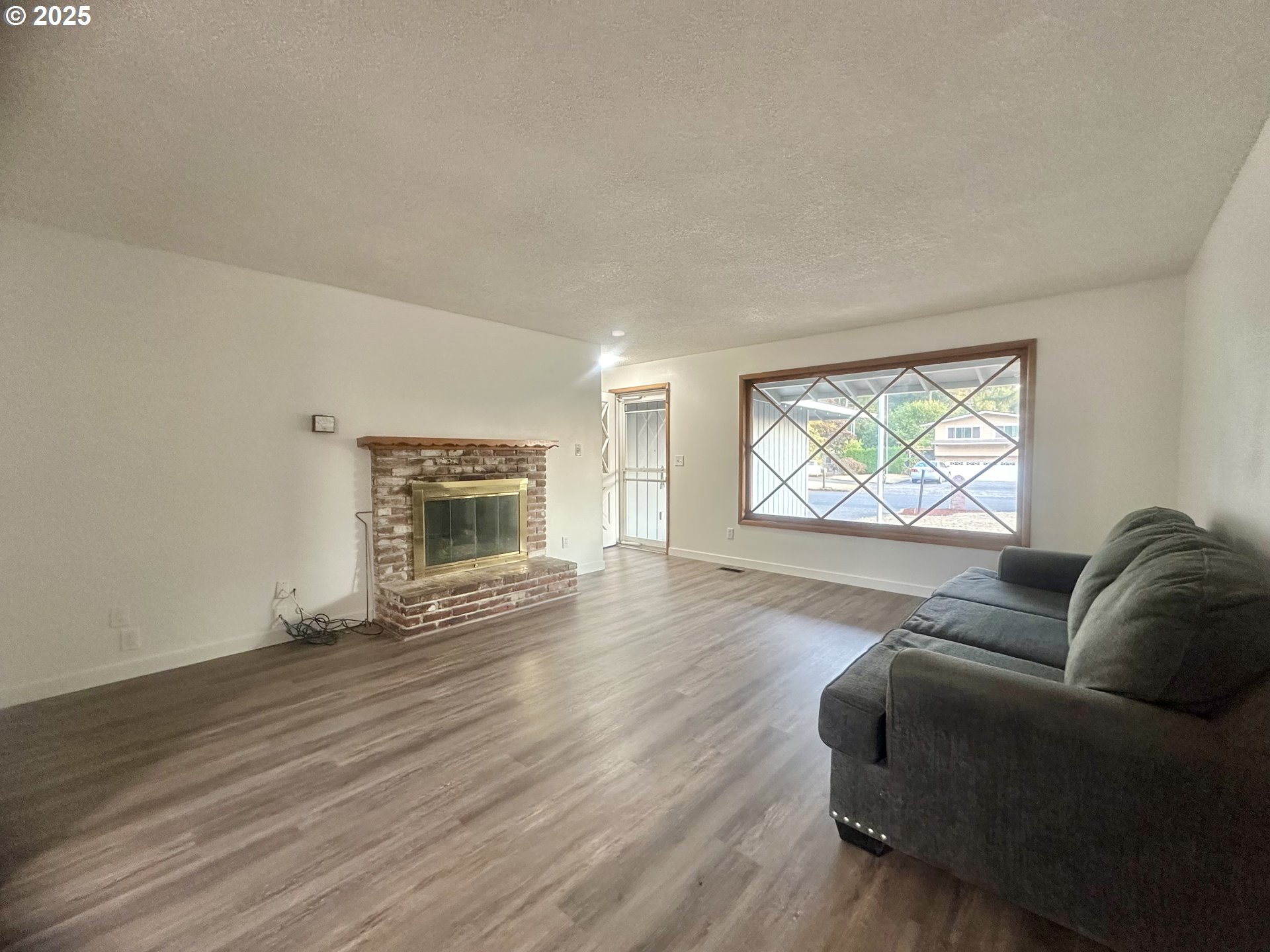 18505 Southeast Clinton Street Gresham, OR 97030 - Photo 4 of 39 a living room with furniture and a fireplace