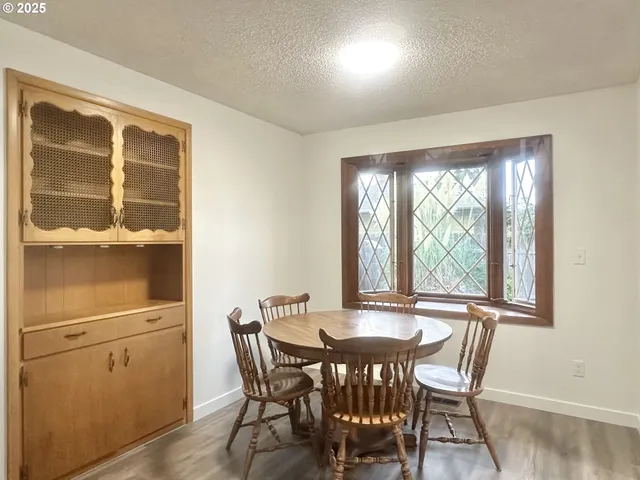 a view of a dining room with furniture and a window