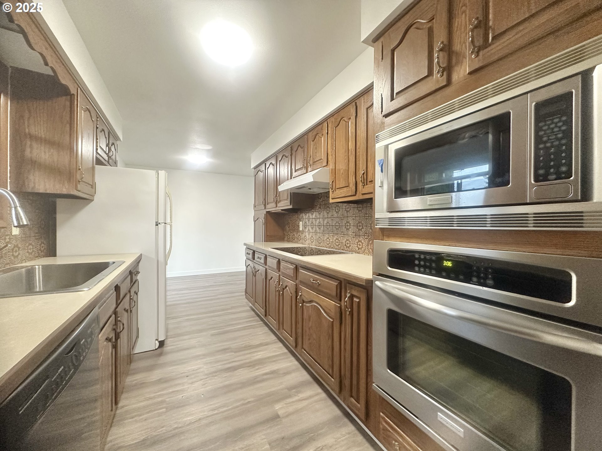18505 Southeast Clinton Street Gresham, OR 97030 - Photo 9 of 39 a kitchen with stainless steel appliances granite countertop a sink and a stove