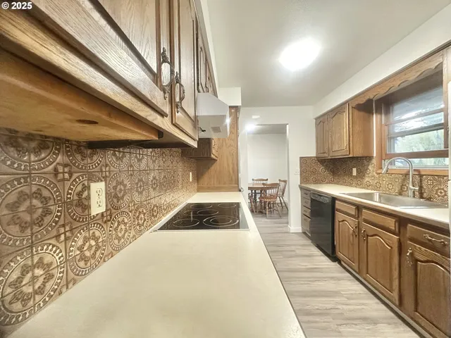 a kitchen with granite countertop a sink and cabinets