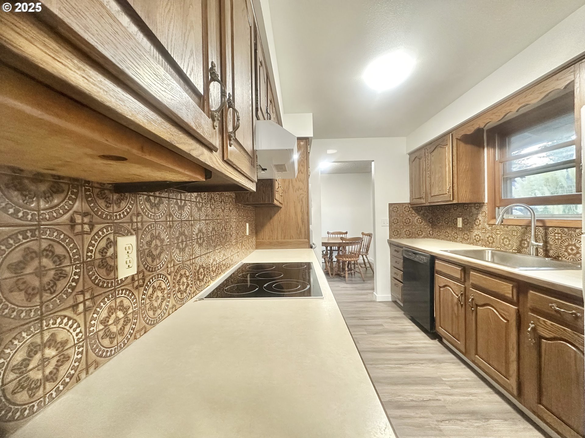 18505 Southeast Clinton Street Gresham, OR 97030 - Photo 10 of 39 a kitchen with granite countertop a sink and cabinets