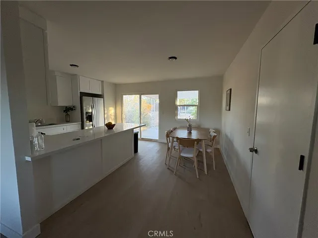 a living room with furniture a dining table a sink and a window