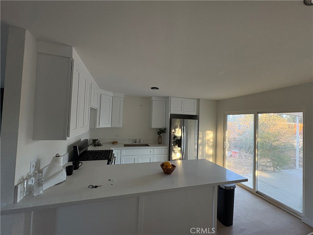 16245 Pine Street Hesperia, CA 92345 - Photo 5 of 5 a kitchen with a sink a stove and refrigerator