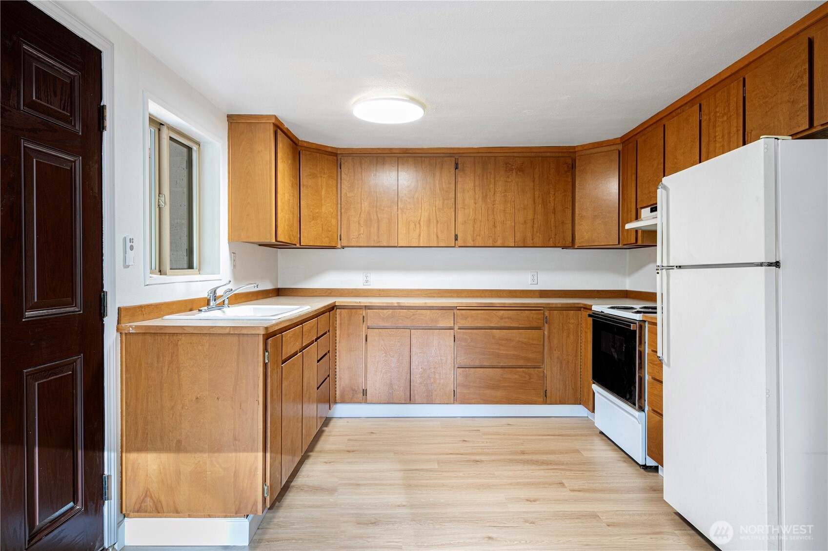 22504 Dorre Don Way Southeast Maple Valley, WA 98038 - Photo 11 of 21 a kitchen with a refrigerator sink and cabinets
