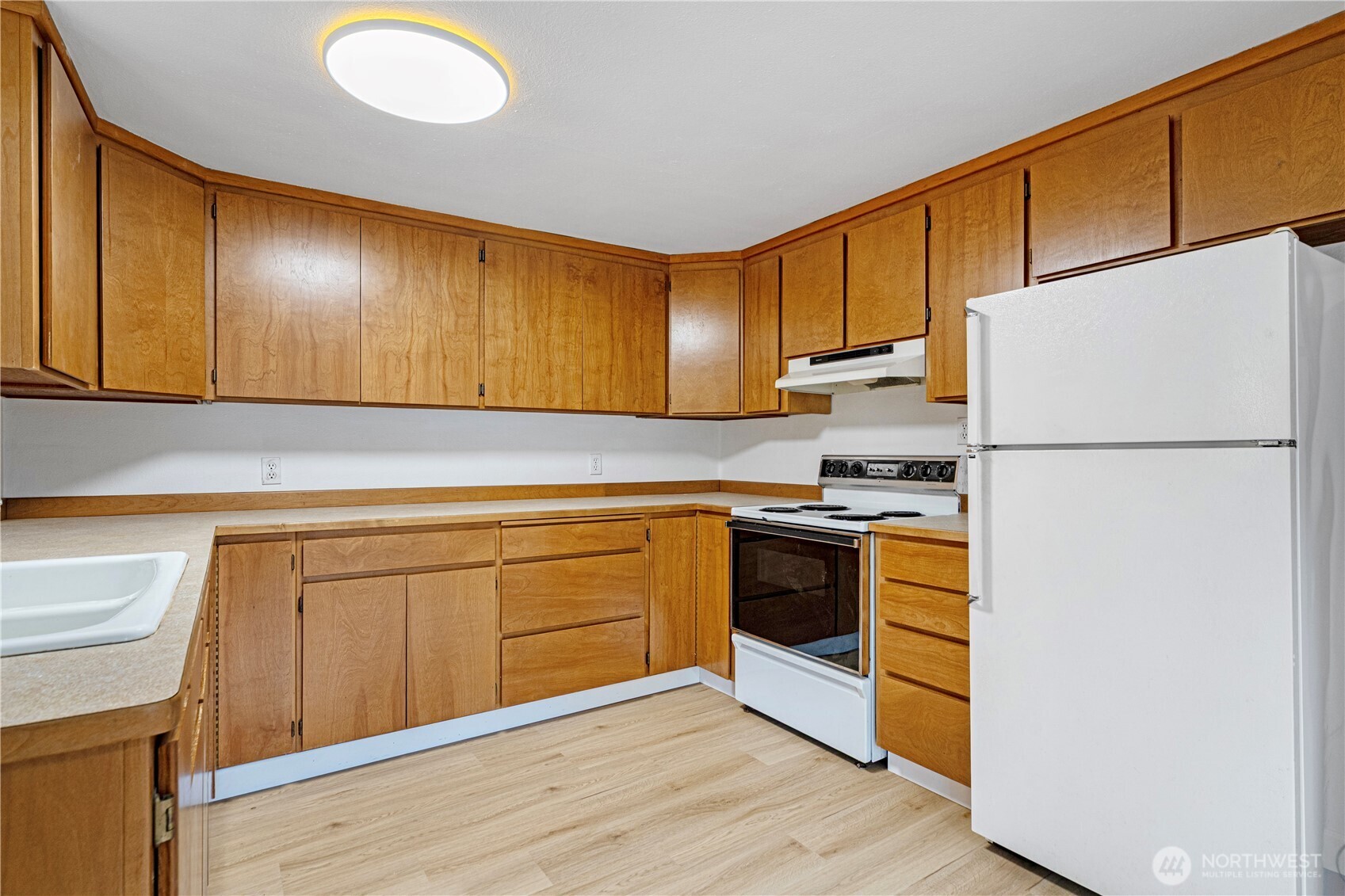 22504 Dorre Don Way Southeast Maple Valley, WA 98038 - Photo 12 of 21 a kitchen with stainless steel appliances granite countertop a refrigerator a stove and a sink