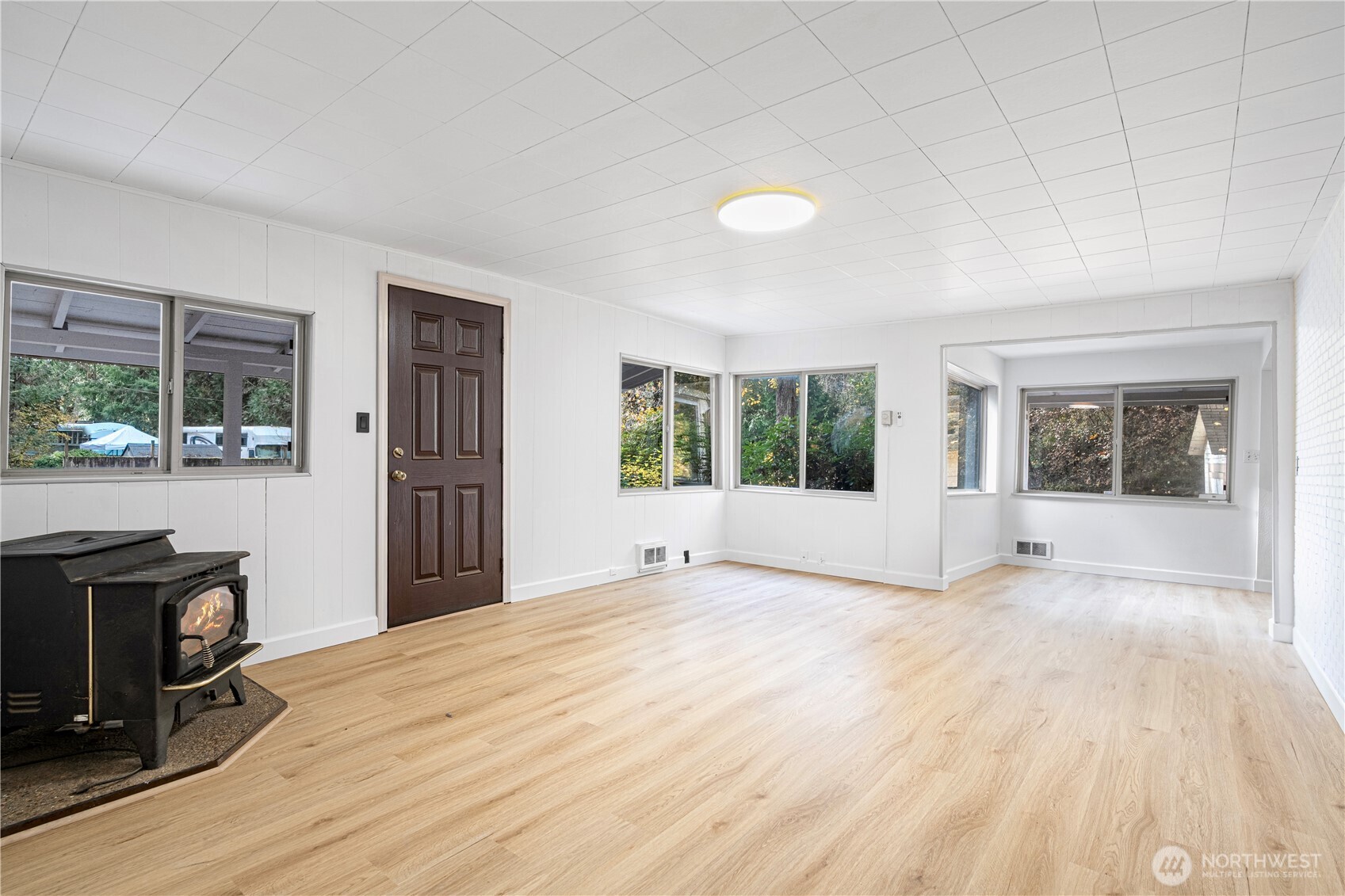 22504 Dorre Don Way Southeast Maple Valley, WA 98038 - Photo 5 of 21 a view of an empty room with a window and wooden floor