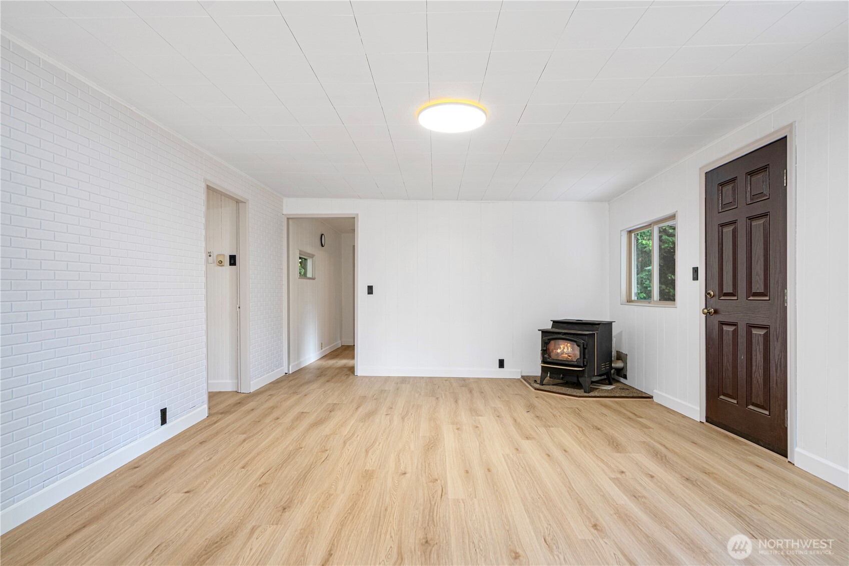 22504 Dorre Don Way Southeast Maple Valley, WA 98038 - Photo 6 of 21 a view of empty room with a fireplace and wooden floor