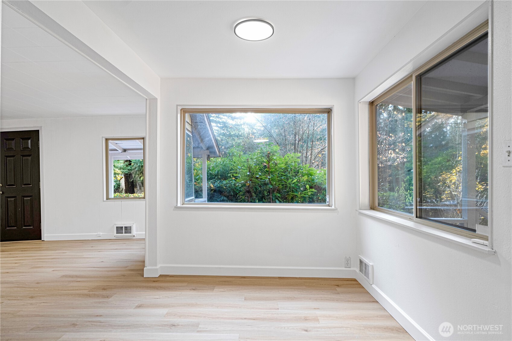 22504 Dorre Don Way Southeast Maple Valley, WA 98038 - Photo 9 of 21 a view of an empty room with wooden floor and a window