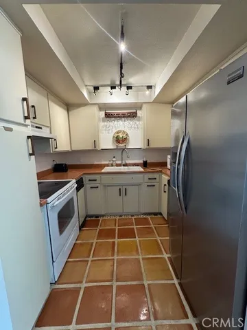a kitchen with a stove sink and cabinets