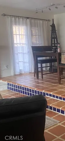 a view of a livingroom with furniture and staircase